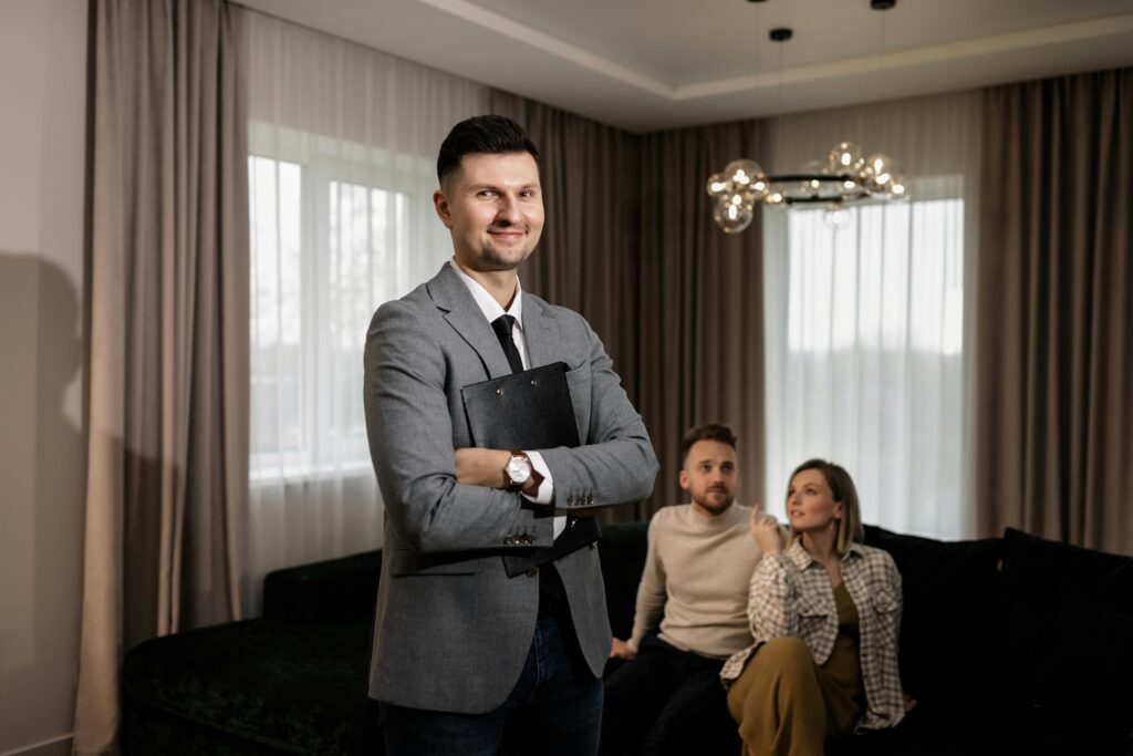 Salesperson holding a clipboard with clients at the back